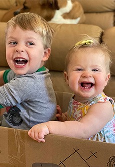 Two children smiling in box