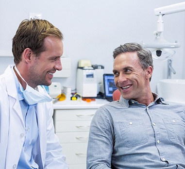 Smiling patient talking to Charleston dentist